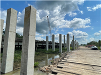 Crews drive piles for the Sabine Relief Bridge replacement.