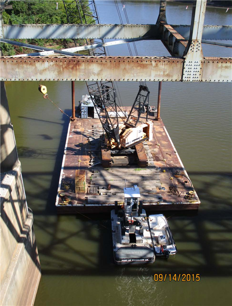 Barge and crane in river to support demolition opertions.